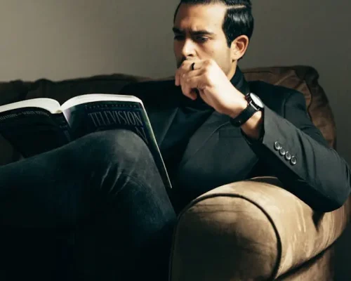 elegant-man-with-book-on-sofa-7063779